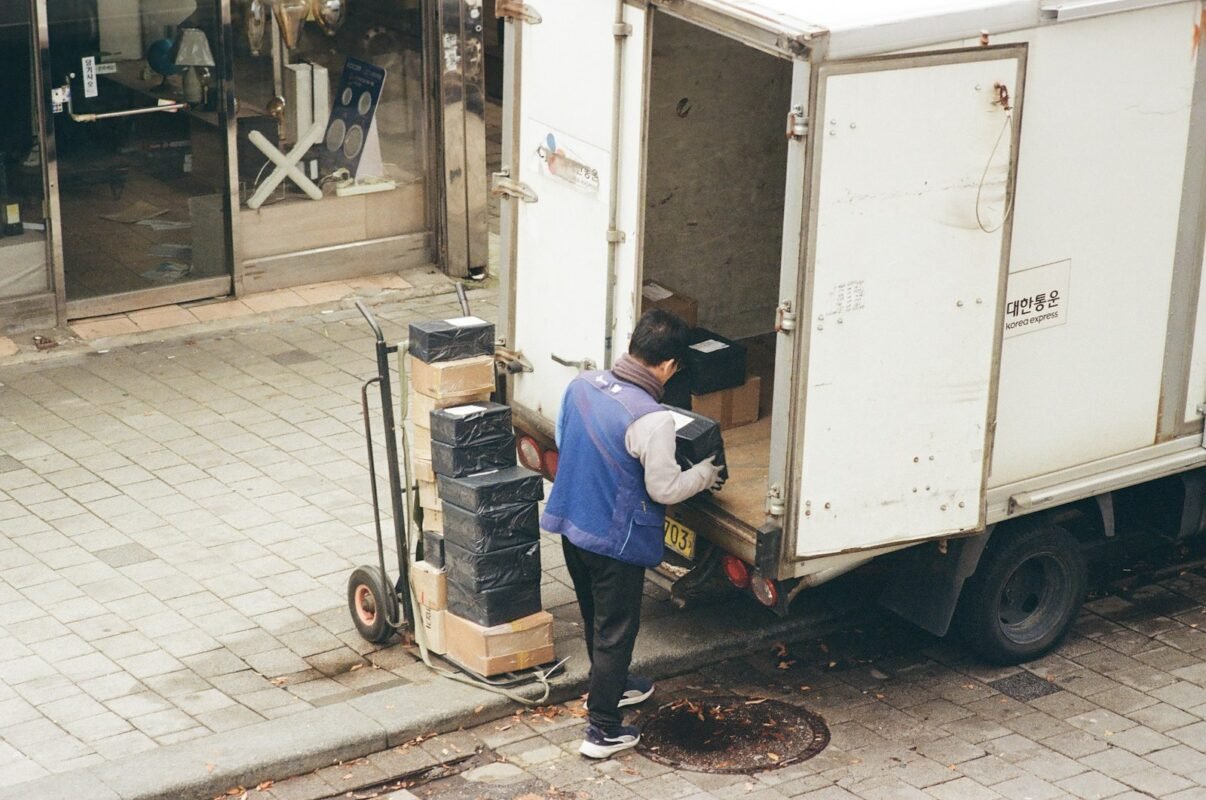 Delivery worker loading boxes from a truck