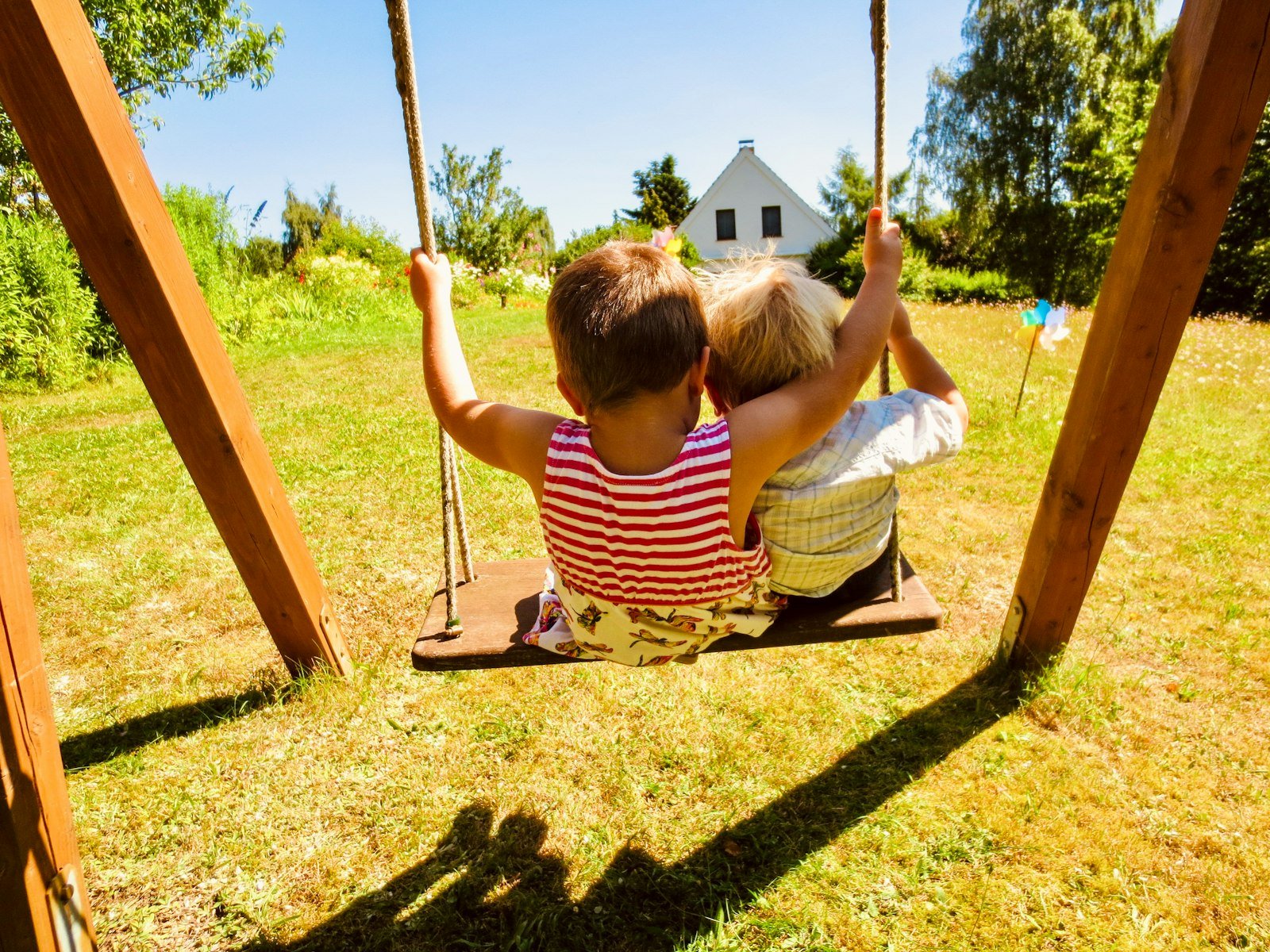 Child playing on a backyard swing set